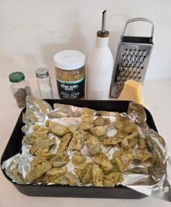 Pan with frozen artichokes, pork rind "Panko" substitute, olive oil, salt, pepper, Parmesan cheese and grater