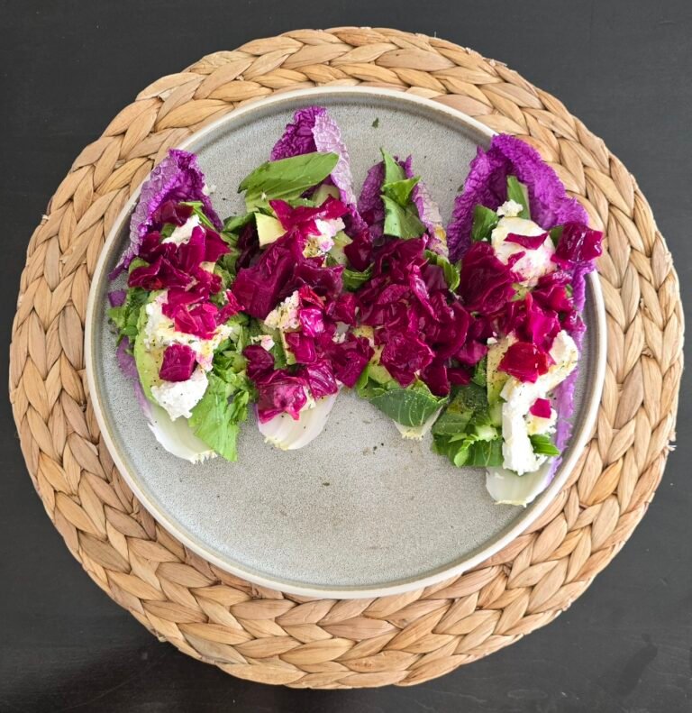 Goat cheese and homemade fermented cabbage on pink napa cabbage salad