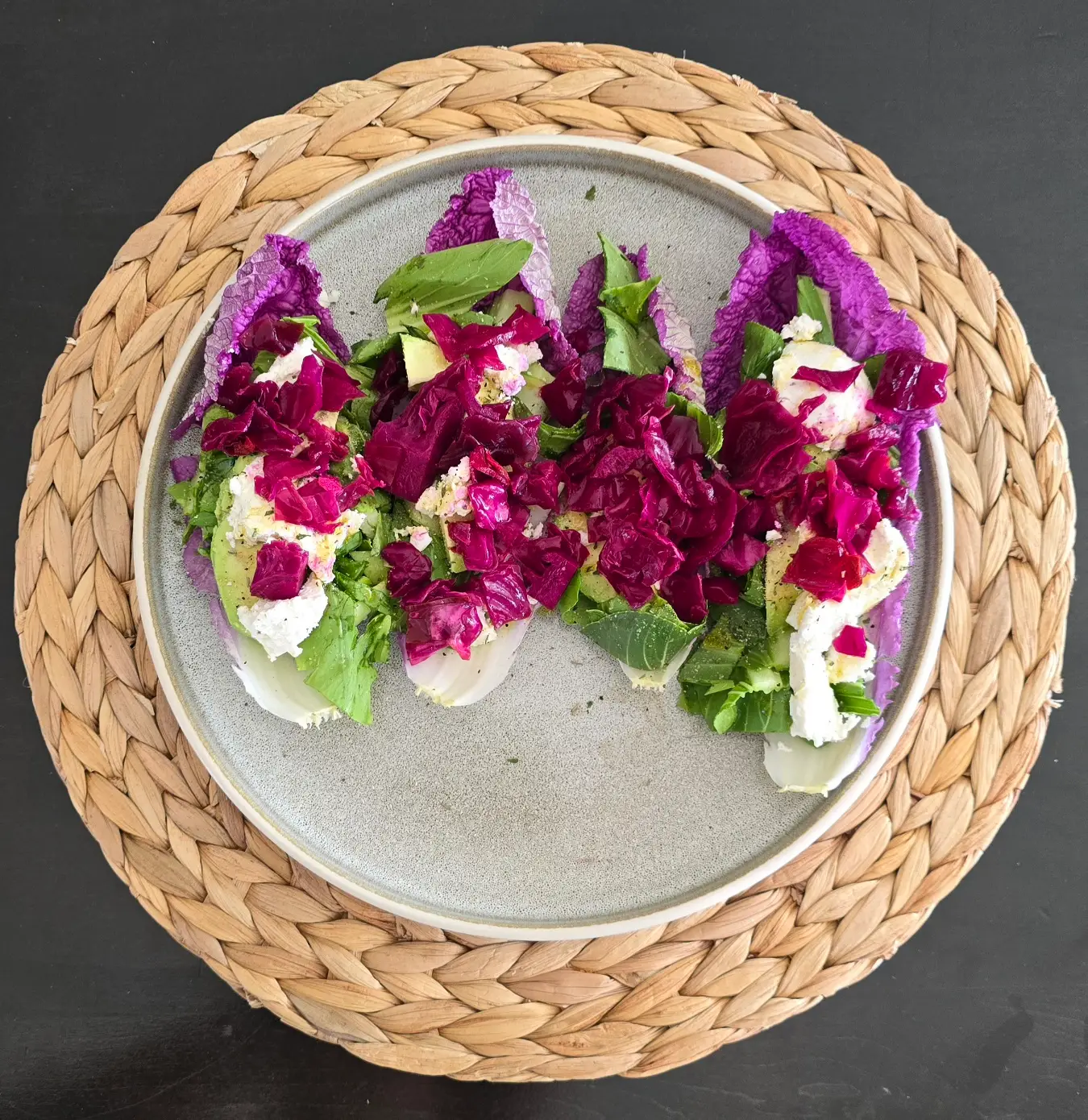 Goat cheese and homemade fermented cabbage on pink napa cabbage salad